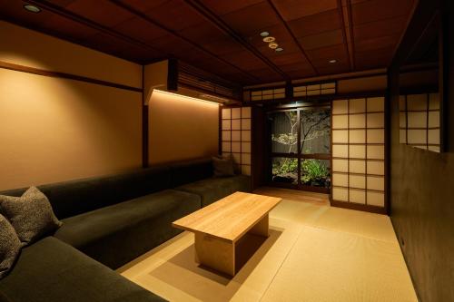a living room with a couch and a table at YADORU KYOTO HANARE Tsukikage No Yado in Kyoto