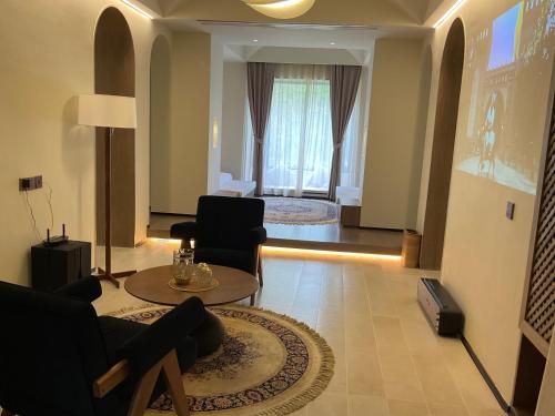 a living room with a couch and chairs and a table at turpan Ah Fanti Village in Turfan