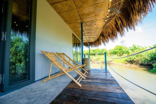 a porch of a house with a wooden staircase at Ann Homestay in Can Tho