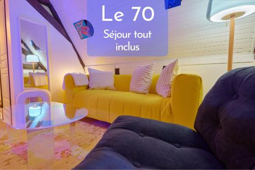 a living room with a yellow couch and a glass table at Le 70 - centre-ville - 2 parkings privé - TOUT INCLUS in Saint-Aignan