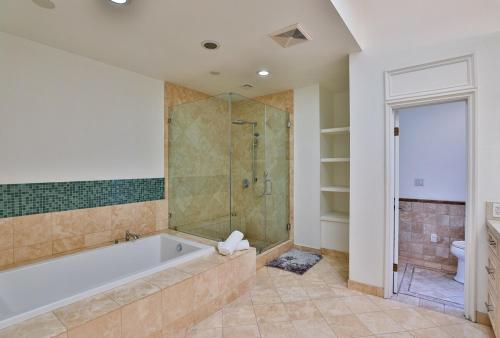 a large bathroom with a tub and a shower at 6BR-Music Studio-Pool-Spa & Games in Sherman Oaks