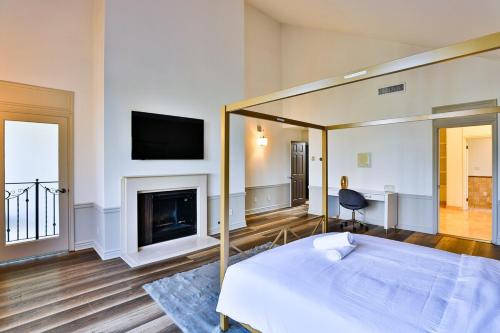 a bedroom with a bed and a fireplace at 6BR-Music Studio-Pool-Spa & Games in Sherman Oaks