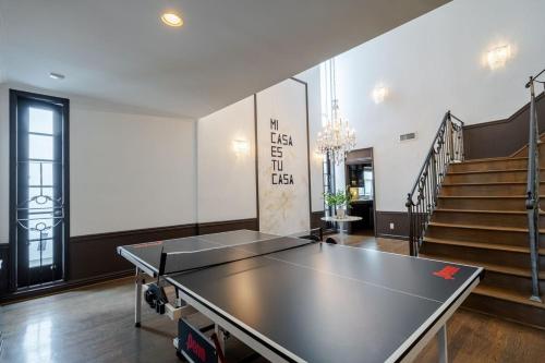 a ping pong table in a room with stairs at 6BR-Music Studio-Pool-Spa & Games in Sherman Oaks
