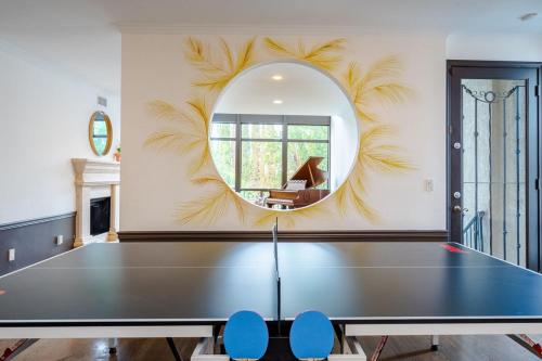 a ping pong table in a room with a mirror at 6BR-Music Studio-Pool-Spa & Games in Sherman Oaks