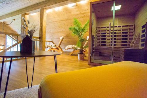 a room with a yellow bed and a table at Chalet Hüttenzauber in Mehlmeisel