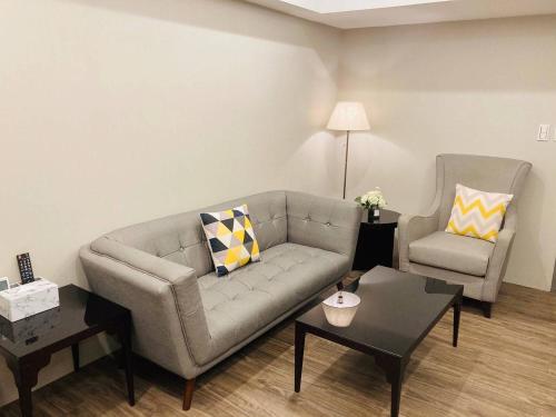 a living room with a couch and a chair at MU House in Taipei