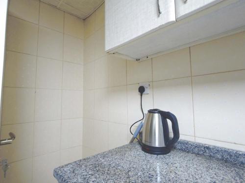 a tea kettle on a counter in a kitchen at One Bedroom Twin Bed Fully Furnished in Sharjah