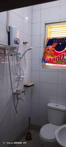a bathroom with a toilet and a bottle of soda at Rogerzi in Bwerenga