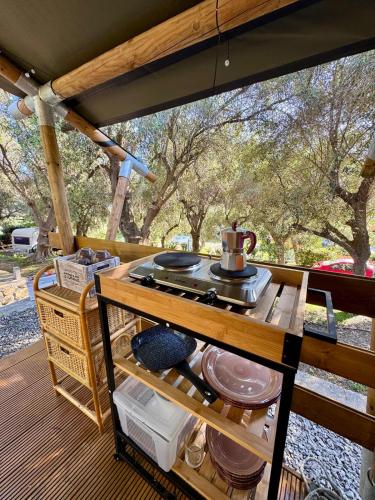 an outdoor kitchen with a stove top on a deck at Camper Village in Santo Stefano al Mare