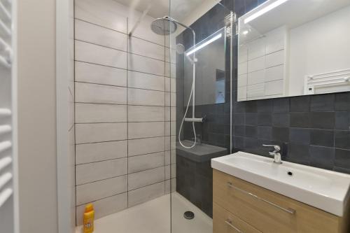 une salle de bain avec un lavabo et une douche dans l'établissement Le Grand Large Vue mer, au Havre