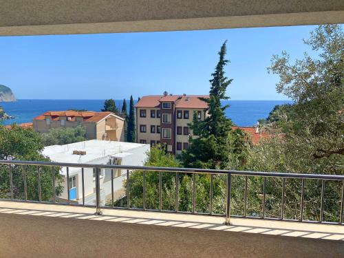 a balcony with a view of the ocean and buildings at Medin Apartments BluVista in Petrovac na Moru