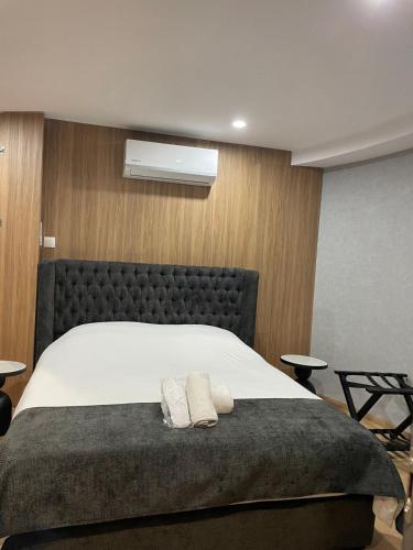 a bedroom with a bed with two towels on it at River Glamping Kalopanayiotis in Kalopanayiotis