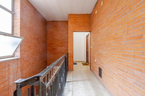 a hallway with a brick wall and a staircase at Priori Loft & Terrace in Terni