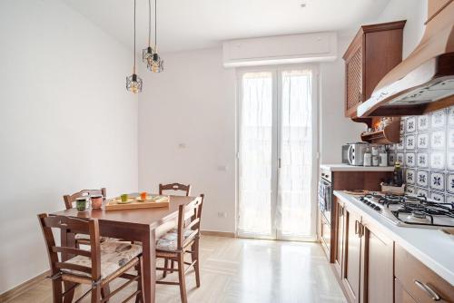 a kitchen with a table and chairs in a room at Priori Loft & Terrace in Terni