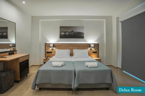 a bedroom with a bed with two towels on it at Kalia Beach in Gouves