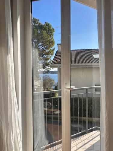 an open window with a view of a balcony at AMoR in Salò
