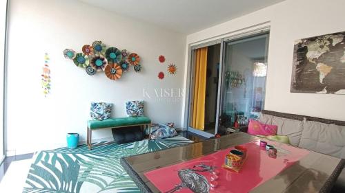 a living room with a table and a couch at Beach Garden Terrace Njivice in Njivice