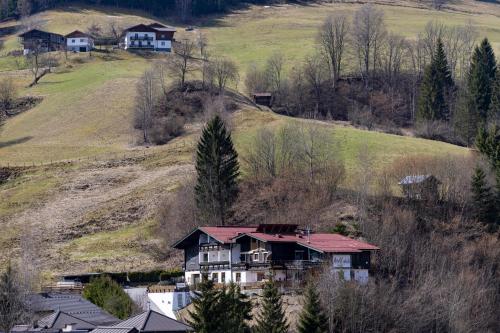a house on a hill with houses on it at Bergvilla Vivaldi - Happy Mountain Vibes in Mühlbach am Hochkönig