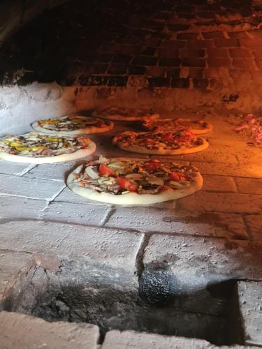 a group of pizzas in a brick oven at Apartmani Nikola in Zastražišće