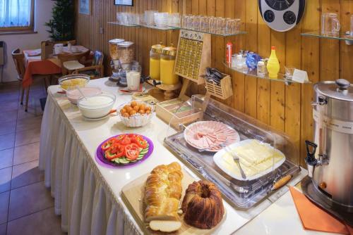 a buffet with bread and other foods on a table at Hotel Tautermann in Innsbruck