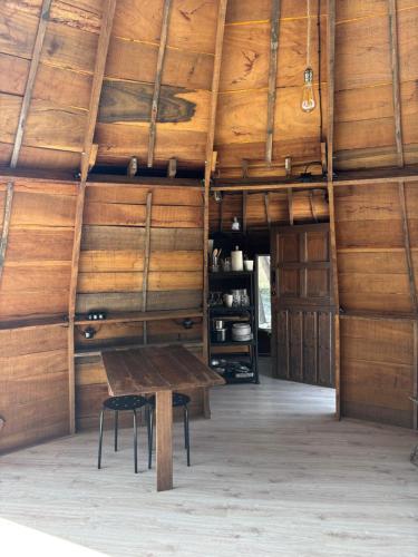 a room with a wooden ceiling with a wooden table at Pink Elephant in Lorca