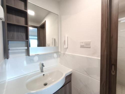 a white bathroom with a sink and a mirror at Forest City 2Bedroom 5 Pax Duty Free in Gelang Patah