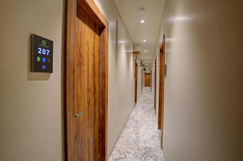 a hallway with a clock on the wall at Starville Hotel Andheri MIDC in Mumbai