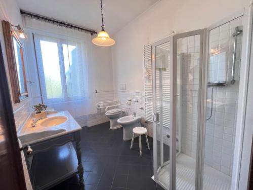 a bathroom with two sinks and a shower and a toilet at Villa Biba tra Lucca e Pisa in Avane