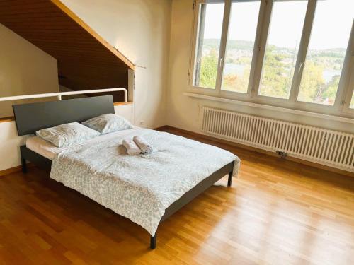 a bedroom with a bed with a stuffed animal on it at Large Flats, Zurich Lake HWA - Self Checkin in Zürich