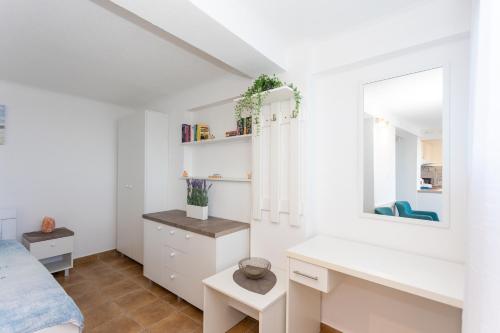 een slaapkamer met een bed, een bureau en een raam bij Apartman Tekoma Herceg Novi in Herceg-Novi