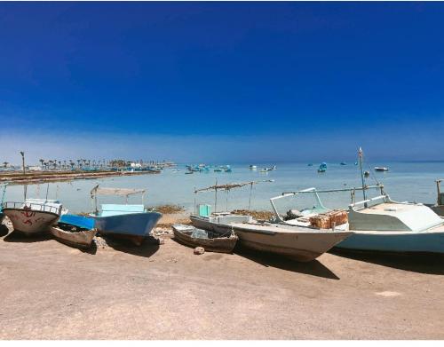 a group of boats sitting on the beach at Sea Life Apartments-hotel in Hurghada