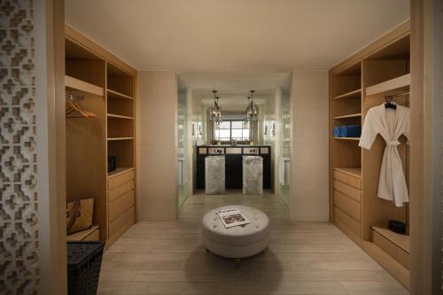 a bathroom with a toilet in the middle of a room at Avista Grande Phuket Karon - MGallery in Karon Beach