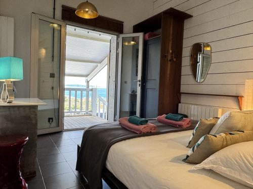 a bedroom with a bed with a view of the ocean at Casadelys in Cala Rossa