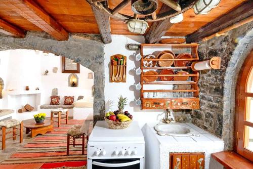 a kitchen with a stove and a sink in a room at Elounda Traditional Homes of Crete in Elounda