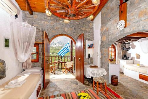 a room with a bath tub and a room with a table at Elounda Traditional Homes of Crete in Elounda
