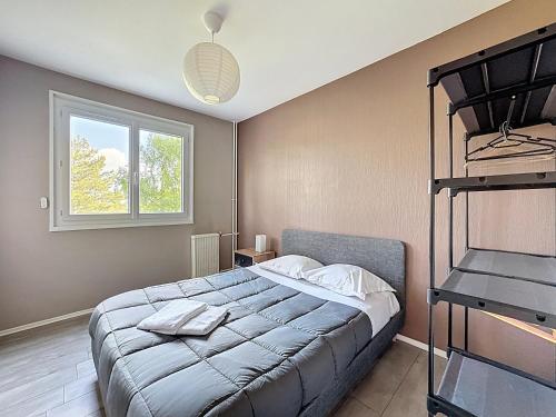 une chambre avec un grand lit et une fenêtre dans l'établissement Chanturgue 90 m2 appart 6 pers, à Clermont-Ferrand