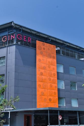 an orange sign on the side of a building at Ginger Vadodara RCR in Vadodara