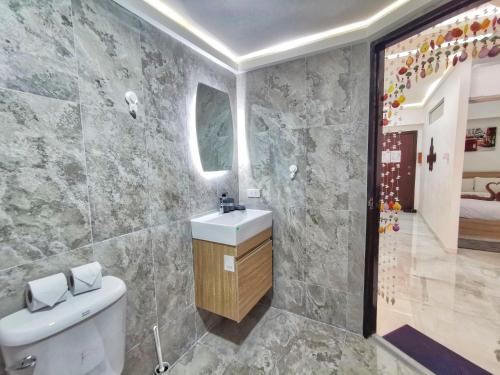 a bathroom with a white toilet and a sink at Hagone-Condotel Pattaya in Pattaya South