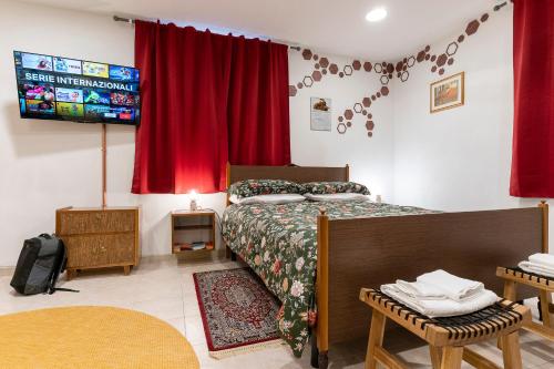 a bedroom with a bed and a red curtain at Nonna Lina in Castel di Ieri