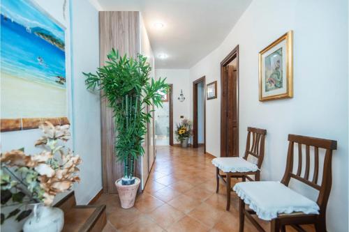 a hallway with chairs and plants in a room at La Sciumara with beach access - Happy Rentals in Cannigione