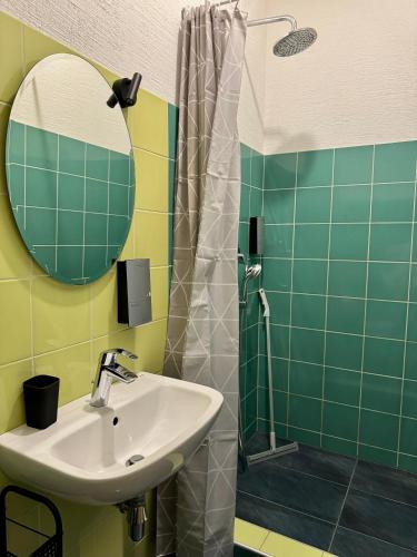 a bathroom with a sink and a shower at Zeit Hotel in Līgatne