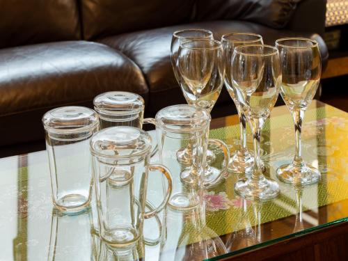 a group of wine glasses on a glass table at Shinjuku Area, Kagurazaka 1min walk, 80sqm,Family Friendly,Free Wi-Fi, PocketWi-Fi in Tokyo