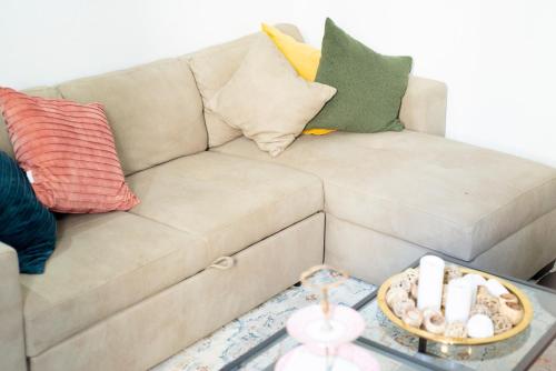 a living room with a couch with pillows and a table at Palazzo 1831 in Nizza Monferrato