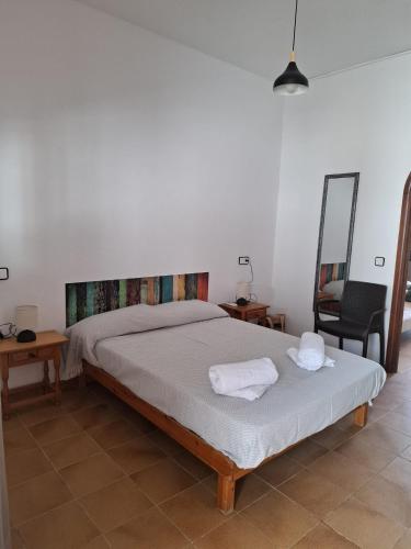 a bedroom with a bed with two towels on it at Ca na Nieves des mestre in Es Calo