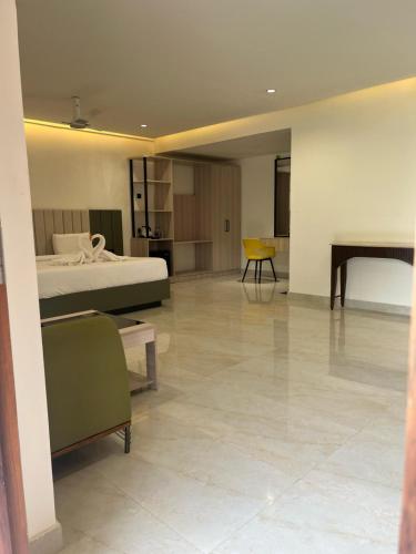 a large room with a bed and a table at Ayana Resorts in Hyderabad