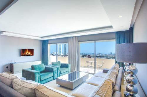 a living room with a couch and chairs and a large window at W-Aldorf in Casablanca