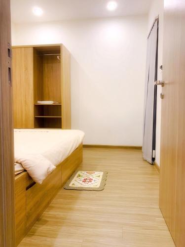 a small bedroom with a bed and a closet at Origami 2BR view Green and Pool in Long Bình