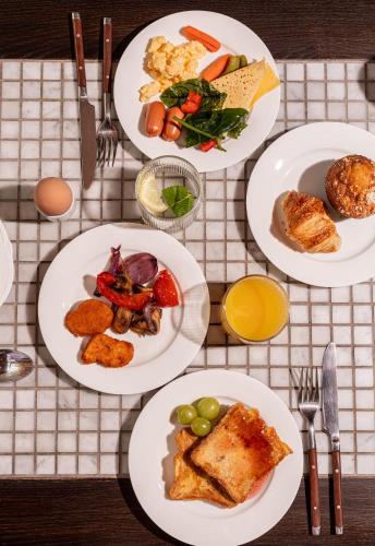 a table with plates of food on it at LEV Lifestyle Hotel - Maestro in Lviv