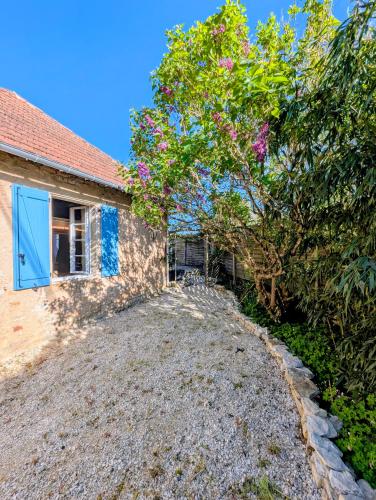 une maison avec une allée en gravier à côté d'un arbre dans l'établissement La chaudière, à Dégagnac