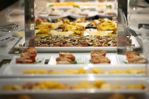 a buffet with many different types of food on plates at Pato Amarillo in Punta Umbría